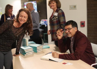 Raj Sisodia signing books at Fireside Chat event at Goodmans